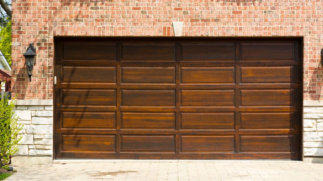 A door is open in a brick building. showcasing features like garage door services garage door repair garage door installation.