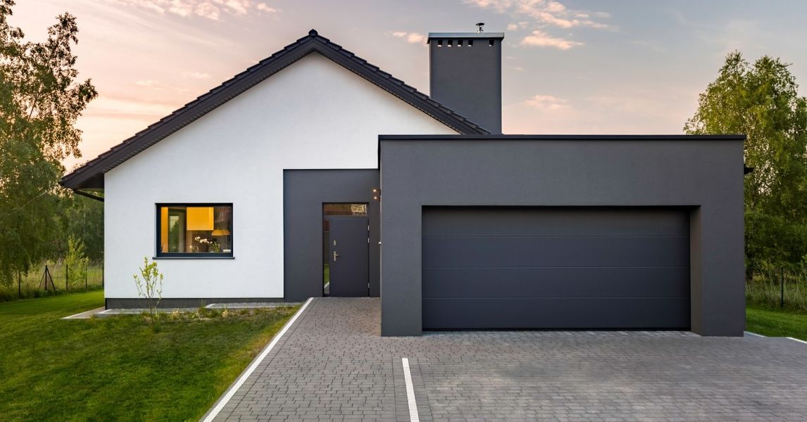 a house with a large window and a large building. features garage door services garage door repair garage door installation garage door spring repair provided by Retrak Door Service.