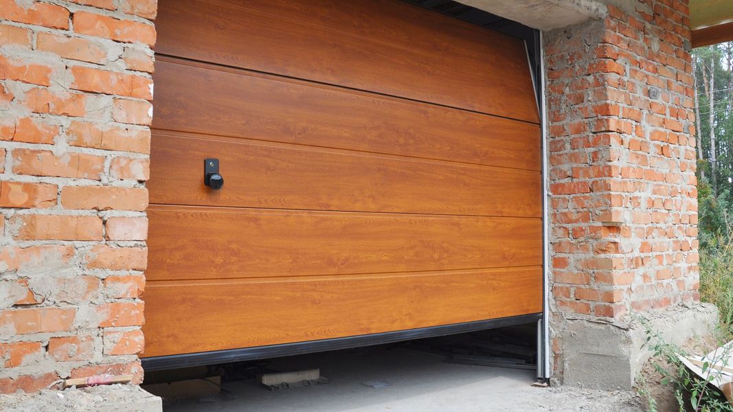 a brick building with a window and a wooden door. features garage door services garage door repair garage door installation garage door spring repair provided by Retrak Door Service.