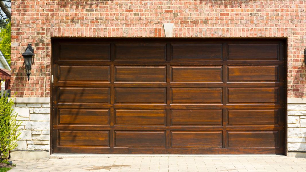 a wooden door with a wooden frame. features garage door services garage door repair garage door installation provided by Retrak Door Service.