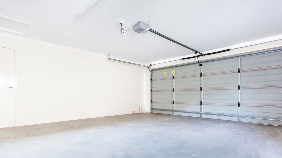 a room with a wall with a door and a wall with a wall mounted wall. features garage door services garage door repair garage door installation garage door spring repair new garage doors emergency garage door service professional garage door service provide