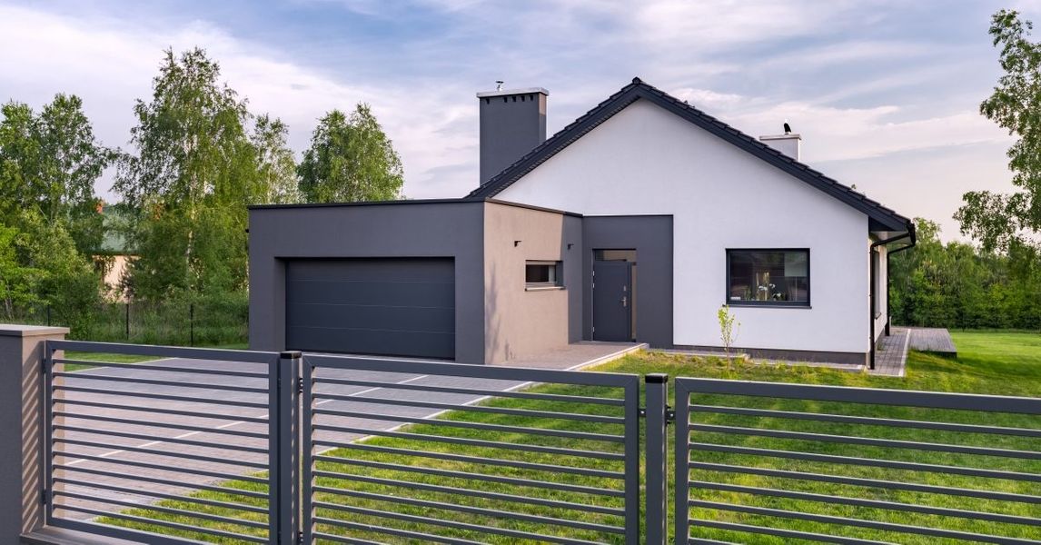 This scene from Lakewood, CO shows a white house with a fence and a fence post. with features such as garage door services garage door repair garage door installation garage door spring repair.