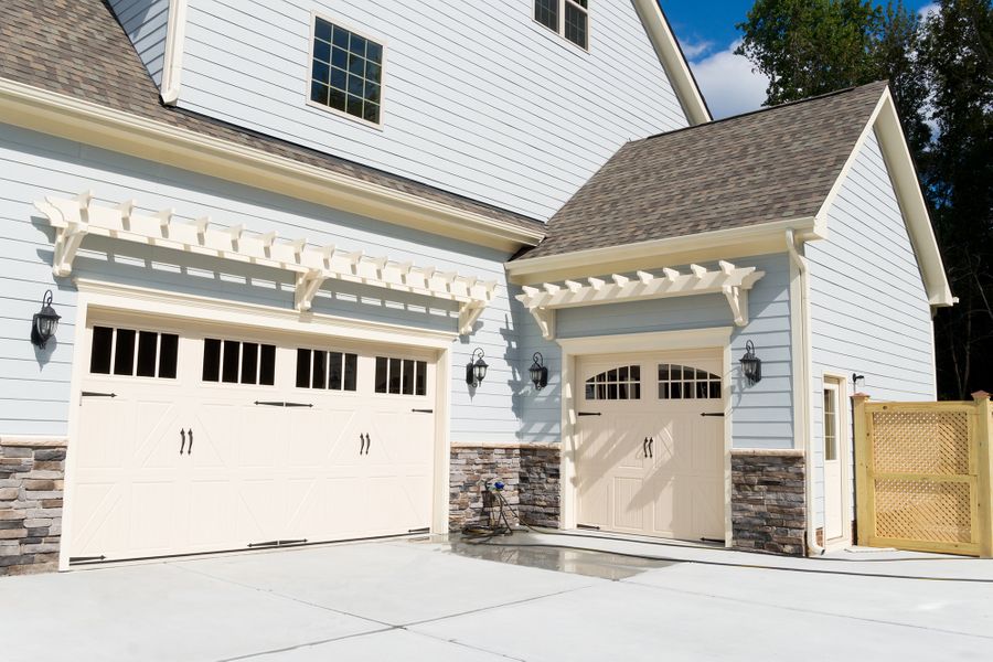 A house with a white roof and a white house. showcasing features like garage door services garage door repair garage door installation garage door spring repair.