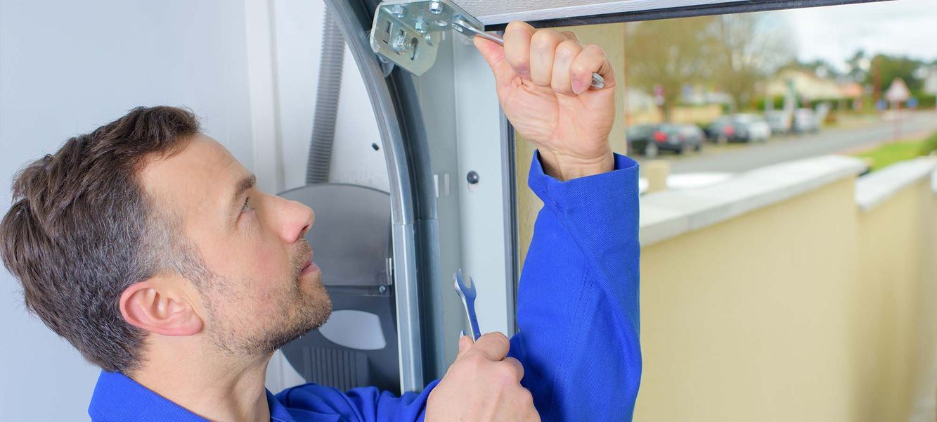 A man holding a bottle in his hand. showcasing features like garage door services garage door repair garage door installation.