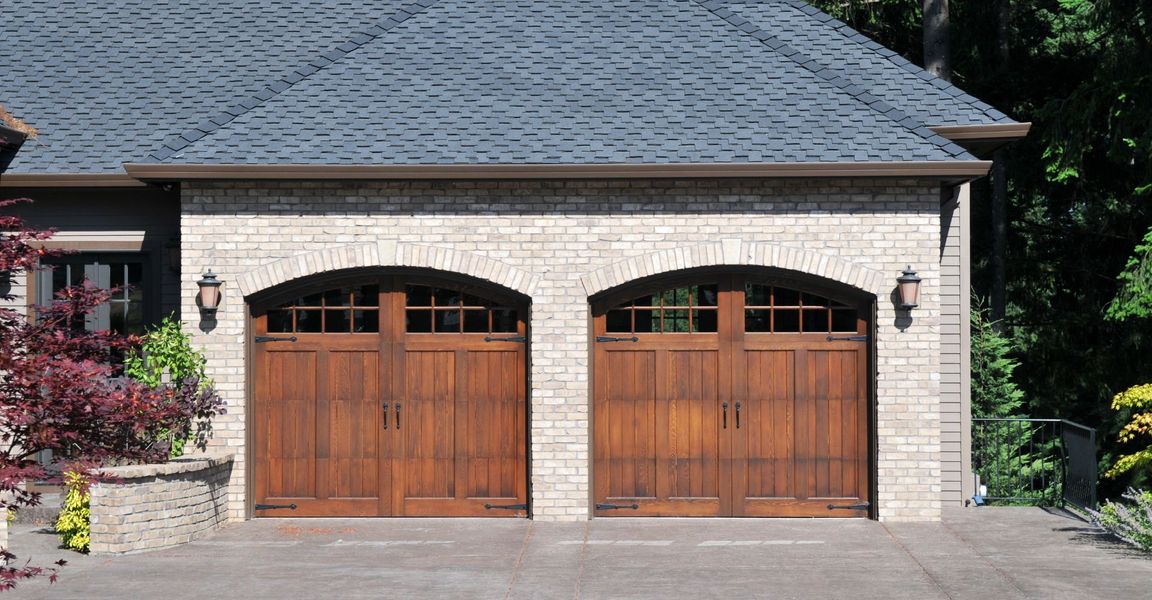 A large brick building with a door open. showcasing features like garage door services garage door repair garage door installation.