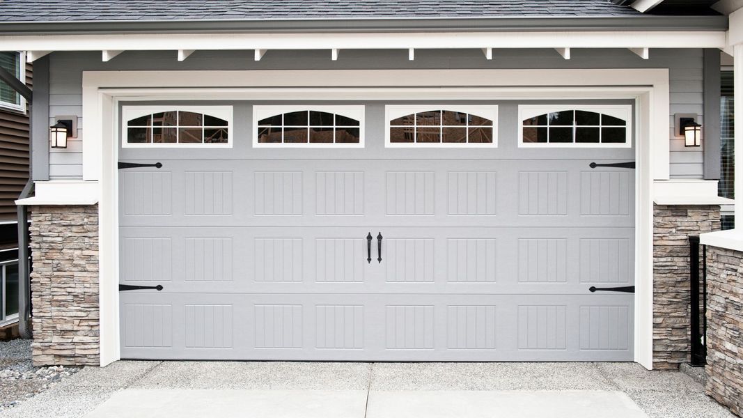 A door leading to a white door with a white door. showcasing features like garage door services garage door repair garage door installation garage door spring repair new garage doors.