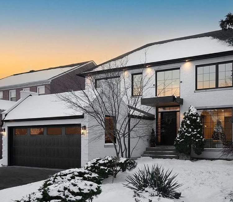 A house with a tree and a building. showcasing features like garage door services garage door repair garage door installation.