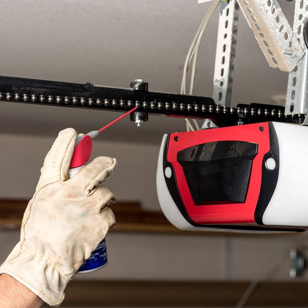 This scene from Lakewood, CO shows a man is holding a hose over his head. with features such as garage door services garage door repair garage door installation garage door spring repair.