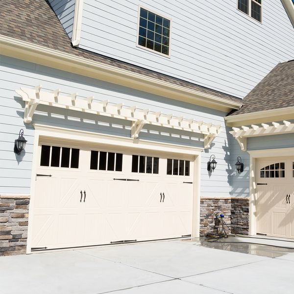 a house with a large window and a large white building. features garage door services garage door repair garage door installation garage door spring repair new garage doors provided by Retrak Door Service.