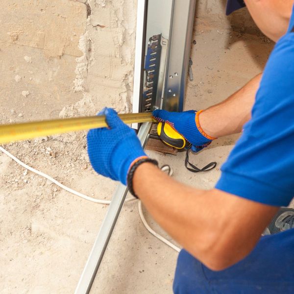 A person is fixing a broken electrical cord. showcasing features like garage door services garage door repair garage door installation.