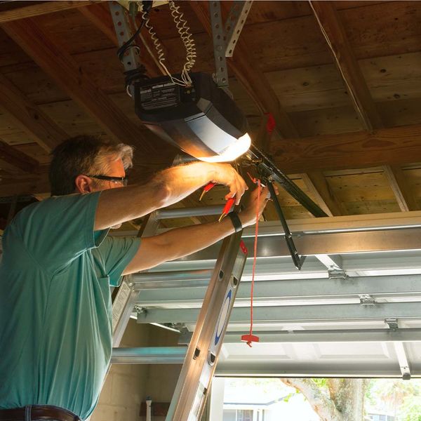 This scene from Lakewood, CO shows a man is cutting a pair of scissors. with features such as garage door services garage door repair garage door installation.