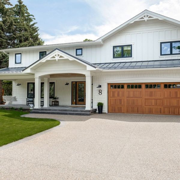 A house with a large white house. showcasing features like garage door services garage door repair garage door installation.