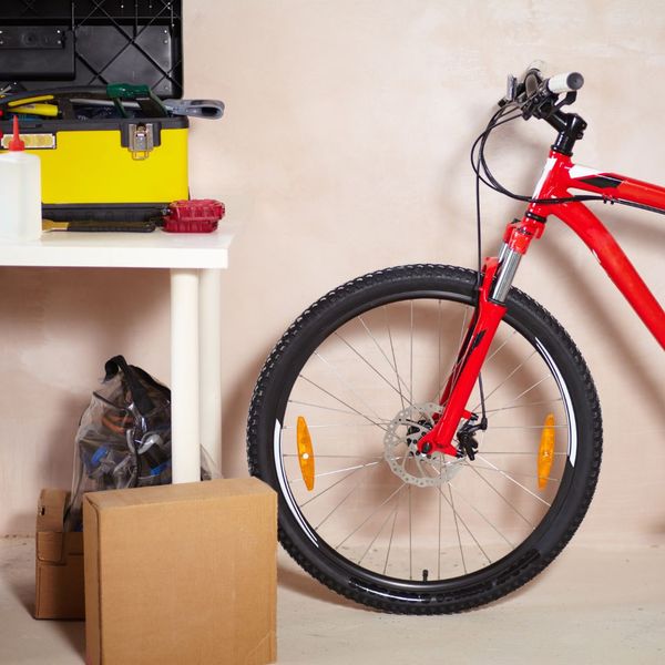 This scene from Lakewood, CO shows a bicycle is parked in a room with a red wall. with features such as garage door services garage door repair garage door installation garage door spring repair new garage doors.