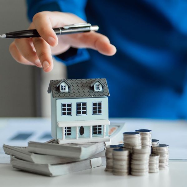 a person holding a remote control in front of a table. features garage door services garage door repair garage door installation garage door spring repair new garage doors provided by Retrak Door Service.