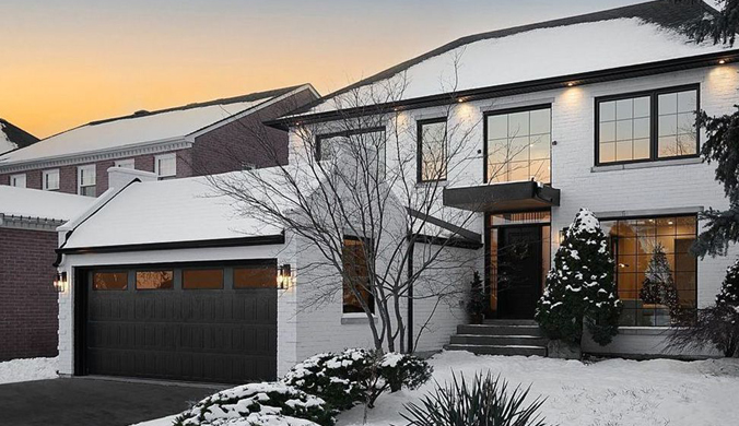 This scene from Lakewood, CO shows a house with a large window and a large building. with features such as garage door services garage door repair garage door installation garage door spring repair.