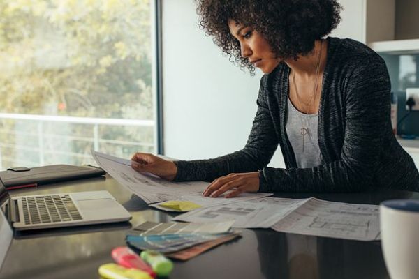 This scene from Lakewood, CO shows a woman sitting at a desk with a paper. with features such as garage door services garage door repair garage door installation garage door spring repair.