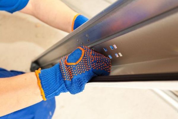 This scene from Lakewood, CO shows a person holding a blue and white baseball bat. with features such as garage door services garage door repair garage door installation garage door spring repair.