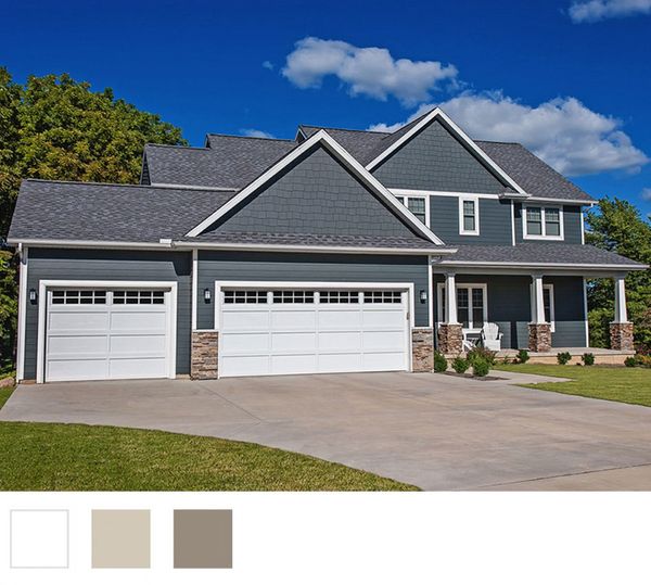 This scene from Lakewood, CO shows a house with a large window and a large house. with features such as garage door services garage door repair garage door installation garage door spring repair.