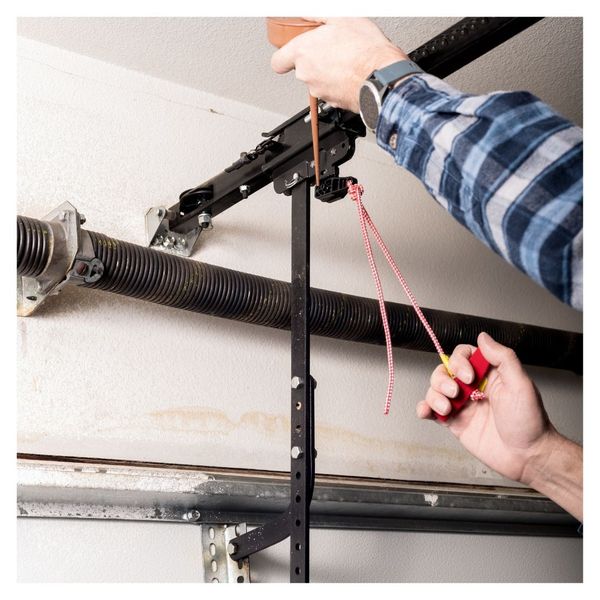 This scene from Lakewood, CO shows a person is tying a wire to a hook. with features such as garage door services garage door repair garage door installation garage door spring repair.