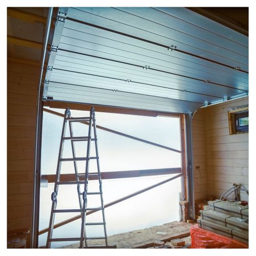 a window with a ladder and a ladder frame. features garage door services garage door repair garage door installation garage door spring repair provided by Retrak Door Service.