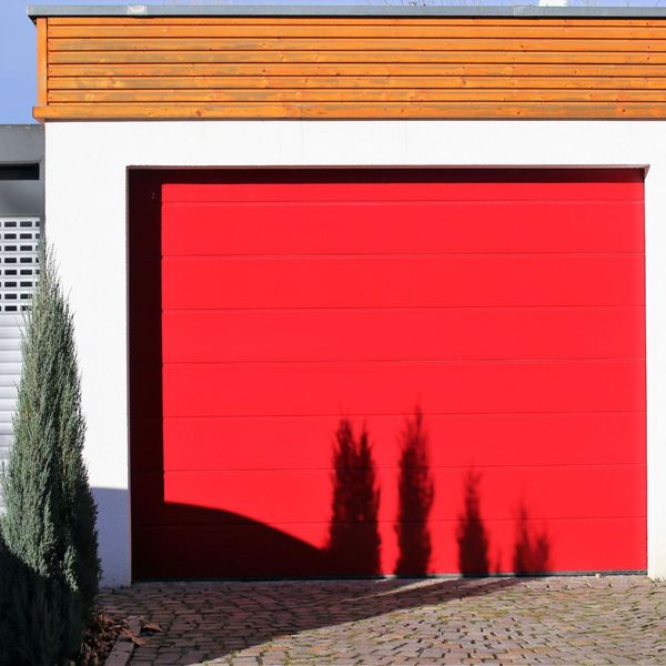 a red door with a red door and a red door. features garage door services garage door repair garage door installation garage door spring repair new garage doors provided by Retrak Door Service.