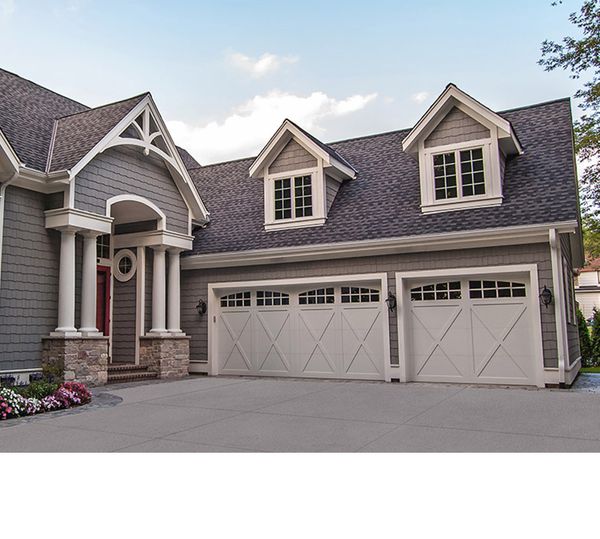 a house with a large window and a large house. features garage door services garage door repair garage door installation garage door spring repair provided by Retrak Door Service.
