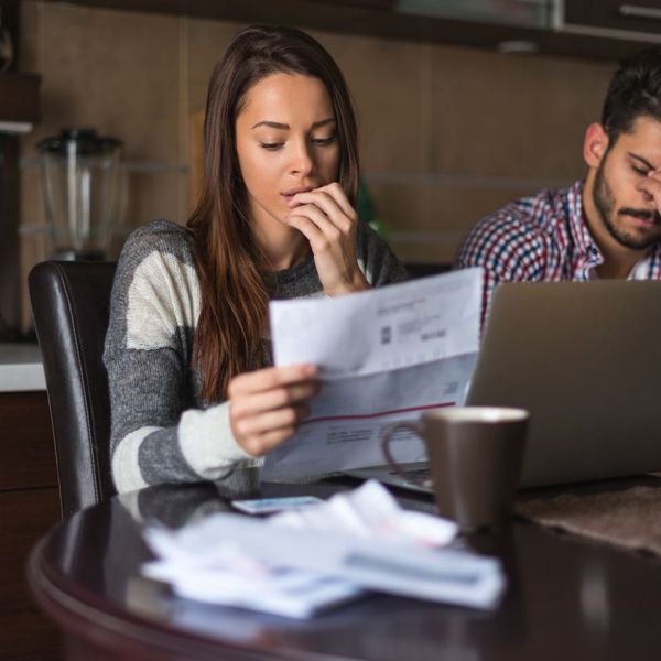 A woman sitting at a desk with a laptop. showcasing features like garage door services garage door repair garage door installation garage door spring repair.