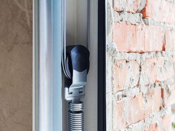 A door is open and a light is on. showcasing features like garage door services garage door repair garage door installation garage door spring repair.