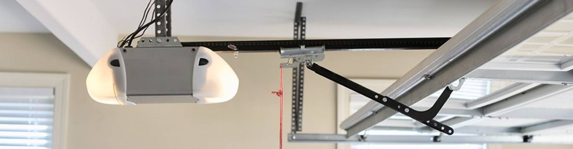 a hanging electrical cord hanging from a ceiling. features garage door services garage door repair garage door installation provided by Retrak Door Service.